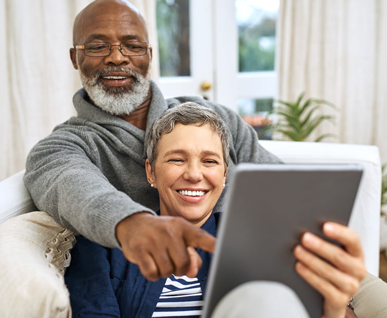 happy couple looking at computer