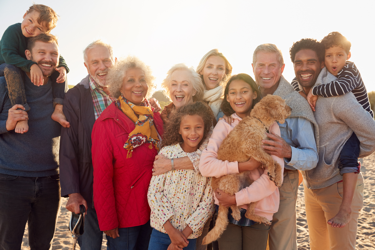 family-friendly dental tips, multigenerational family smiling on the beach in winter, dentist in Granbury