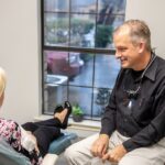 Dr. Paul Froude meeting with a dental patient in personalized dental care visit